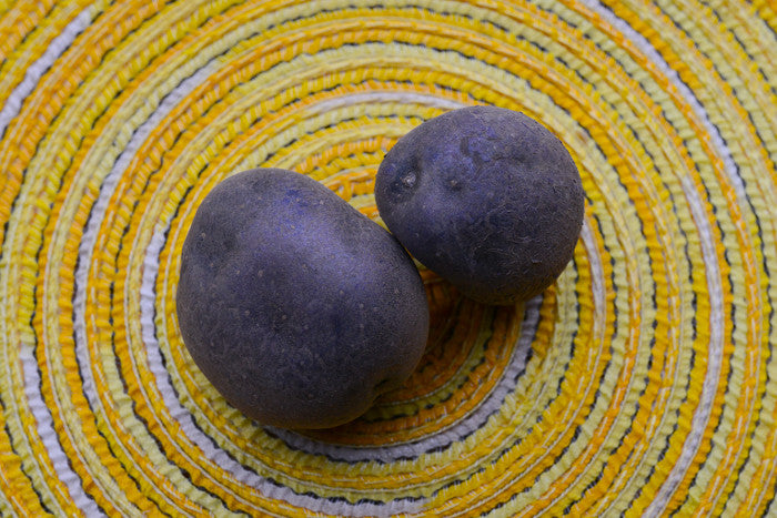 Organic Purple Majesty potato seed round from SeedsNow-Potatoes, showcasing vibrant purple skin and fresh, healthy appearance.