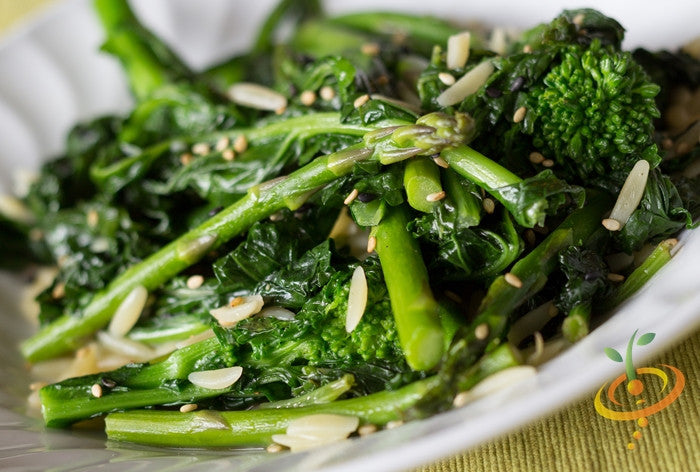 Close-up of fresh broccoli and rapini (Raab) seeds from SeedsNow, showing vibrant green florets and seed packaging.