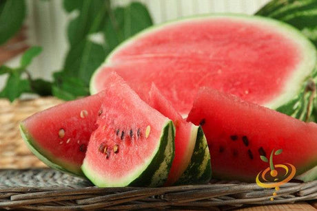 Slices of large, ripe All Sweet Watermelon with bright red flesh and seeds on a wicker surface
