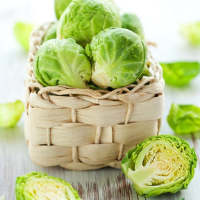Fresh Brussels sprouts from SeedsNow, grown from Long Island Catskill seeds, shown on a wooden surface.